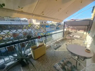 a balcony with a table and chairs and a view of a pool at Exarchia Penthouse Cozy & Central in Athens