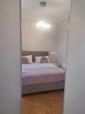 a bedroom with a bed with a pink blanket at Exarchia Penthouse Cozy & Central in Athens