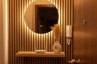a bathroom with a mirror and a vase on a shelf at Serenity Luxury Estates in Piraeus