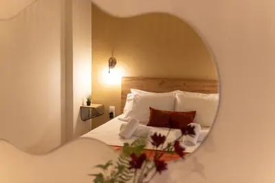 a bedroom with a bed with a mirror at Serenity Luxury Estates in Piraeus
