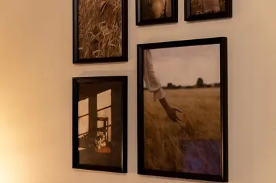 a group of framed pictures hanging on a wall at Serenity Luxury Estates in Piraeus