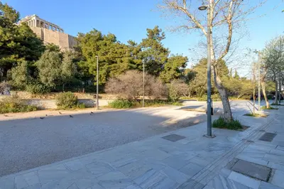 an empty parking lot with birds on the street at Acropolis Loom Suite in Athens