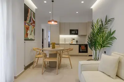 a kitchen and living room with a table and chairs at Acropolis Loom Suite in Athens