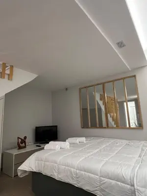 a white bedroom with a bed and a television at Athens Hotspot Residence in Athens