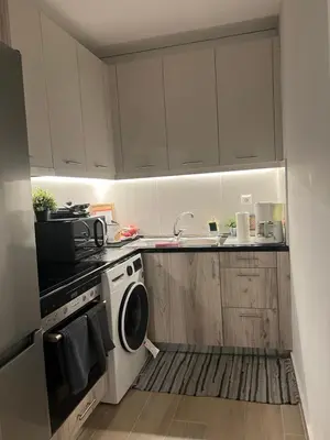 a kitchen with white cabinets and a stove and a microwave at Athens Hotspot Residence in Athens