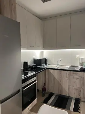 a kitchen with white cabinets and a stove top oven at Athens Hotspot Residence in Athens