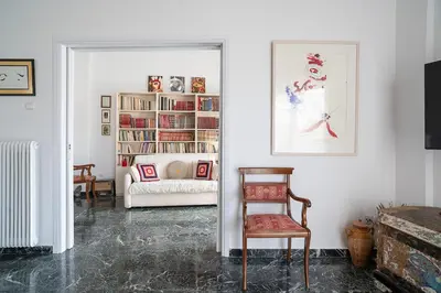 a living room with a chair and a couch at Florou's art-gallery apartment, Kypseli in Athens