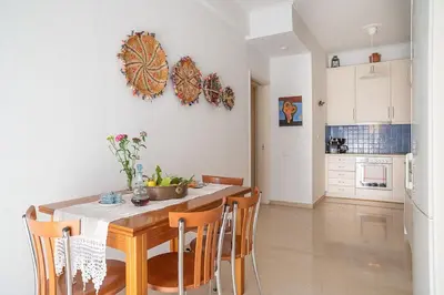 a kitchen and dining room with a table and chairs at Florou's art-gallery apartment, Kypseli in Athens