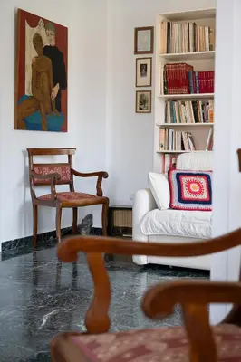 a living room with a couch and a chair at Florou's art-gallery apartment, Kypseli in Athens