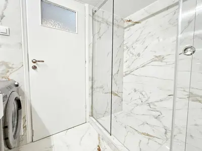 a bathroom with a shower and a washing machine at Athens Belvedere Palace in Athens