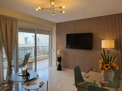 a living room with a tv on a striped wall at Acropolis Calm Escape-Central 2 min from the metro in Athens