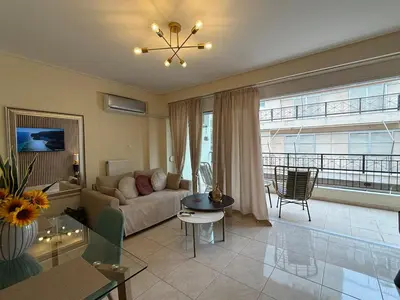 a living room with a couch and a table at Acropolis Calm Escape-Central 2 min from the metro in Athens