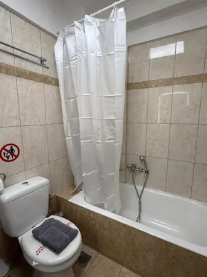 a bathroom with a toilet and a bathtub with a shower curtain at Acropolis Calm Escape-Central 2 min from the metro in Athens