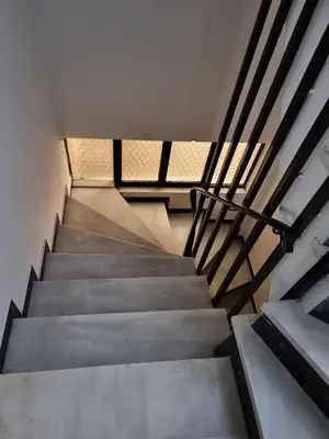 a staircase in a building with a metal railing at from Space to well-Designed COMFY in Piraeus