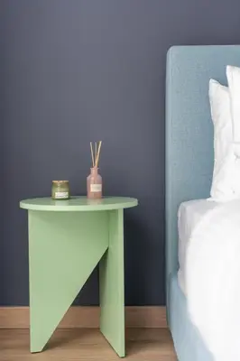 a table next to a bed next to a side table at Praxitelous Hideout in Athens