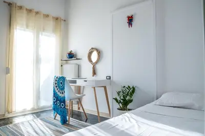 a bedroom with a bed and a desk and a chair at Comfortable two bedroom Athens appartment - Sando in Athens