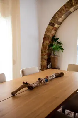 a wooden table with a branch on top of it at Comfortable two bedroom Athens appartment - Sando in Athens