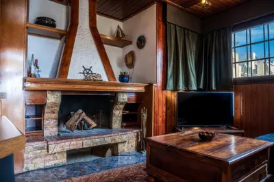 a living room with a fireplace and a tv at Comfortable two bedroom Athens appartment - Sando in Athens