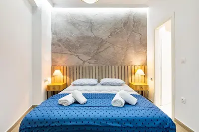 a bedroom with a blue bed with towels on it at Artistic Stay in the Heart of Athens in Athens
