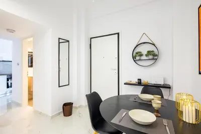 a dining room with a black table and black chairs at Artistic Stay in the Heart of Athens in Athens
