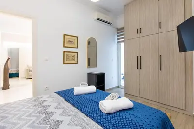 a bedroom with a blue bed with towels on it at Artistic Stay in the Heart of Athens in Athens