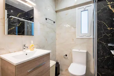 a bathroom with a sink and a toilet and a shower at Artistic Stay in the Heart of Athens in Athens