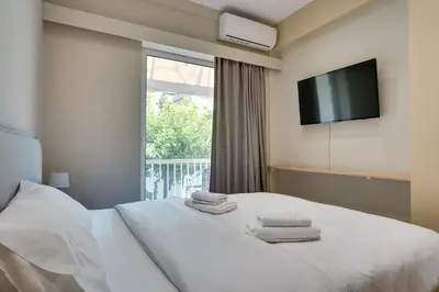 a hotel room with a bed with towels on it at Amazing house close to sea in Athens