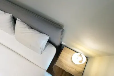 a bedroom with a bed with a lamp on it at Amazing house close to sea in Athens
