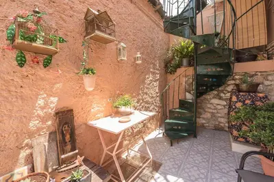 an outdoor patio with a table and potted plants at Charming Vintage Retreat in Athens