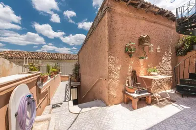 an outdoor patio with a table and a building at Charming Vintage Retreat in Athens