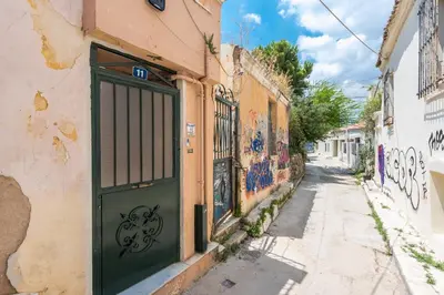 a green door in an alley with graffiti at Charming Vintage Retreat in Athens