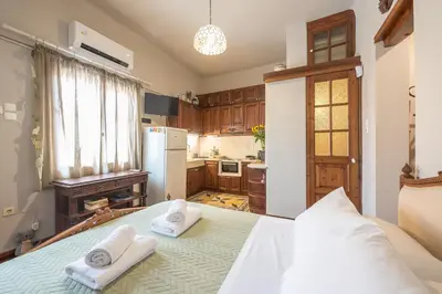 a kitchen with a bed with two towels on it at Charming Vintage Retreat in Athens