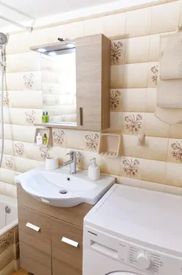 a bathroom with a sink and a washing machine at Sunny Penthouse For balcony lovers in Athens