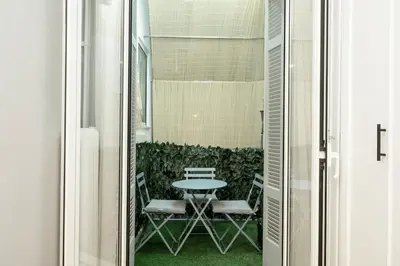 a patio with a table and chairs in a room at FilOikos Syntagma Spacious Suite 5Br 2,5Ba in Athens