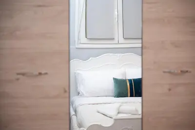 a room with a white bed with pillows at FilOikos Syntagma Spacious Suite 5Br 2,5Ba in Athens