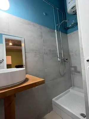 a bathroom with a shower and a sink and a tub at Quiet Little Studio in Kolonaki in Athens