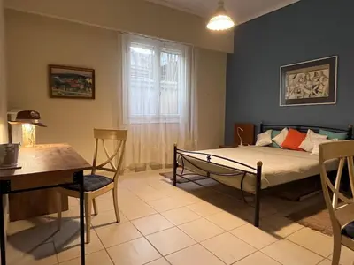 a bedroom with a bed and a table and chairs at Quiet Little Studio in Kolonaki in Athens