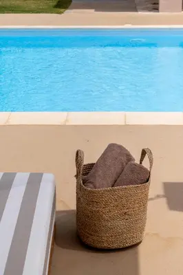 a basket sitting on the ground next to a pool at Villa Hyacinth by A&D Properties in Porto Rafti
