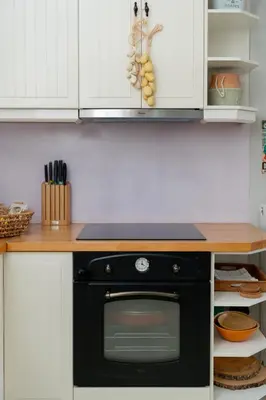 a black stove in a kitchen with white cabinets at Villa Hyacinth by A&D Properties in Porto Rafti