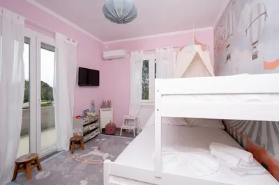a bedroom with pink walls and a bunk bed at Villa Hyacinth by A&D Properties in Porto Rafti