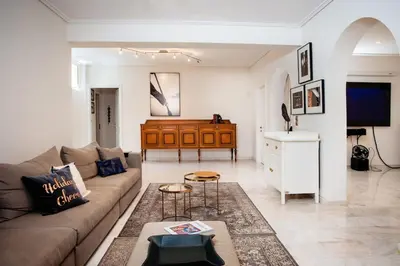 a living room with a couch and a table at South Blue Tranquil Villa in Athens