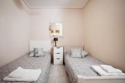 a bedroom with two beds and a mirror at South Blue Tranquil Villa in Athens