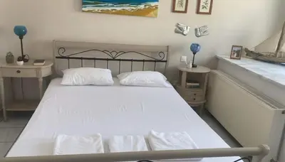 a bedroom with a white bed and a window at Luxury apt in Pagkrati in Athens