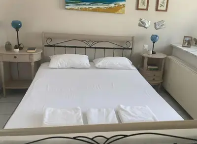 a bedroom with a large white bed with two tables at Luxury apt in Pagkrati in Athens