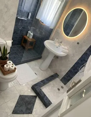 a bathroom with a sink and a shower and a toilet at Luxury apt in Pagkrati in Athens