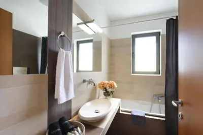 a bathroom with a sink and a toilet and a tub at Saronida Seaside Serenity in Saronida