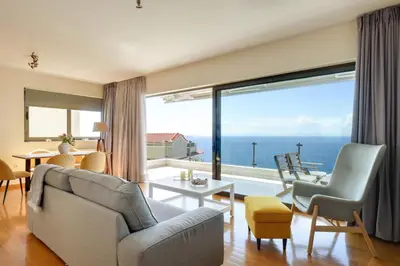 a living room with a view of the ocean at Saronida Seaside Serenity in Saronida