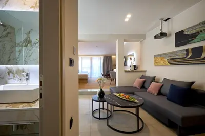 a living room with a couch and a table at Athens City Suites in Athens