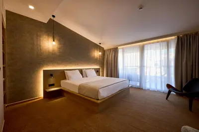 a hotel room with a bed and a window at Athens City Suites in Athens