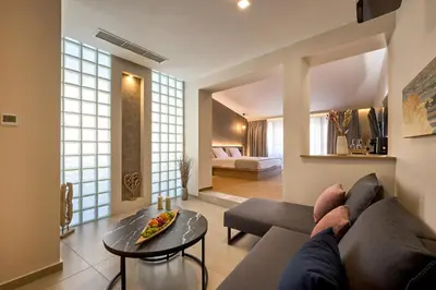 a living room with a couch and a table at Athens City Suites in Athens